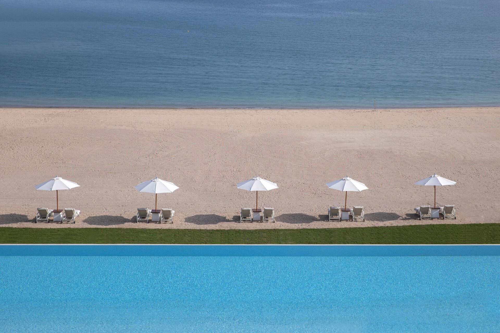 Spend your lazy days by the massive infinity pool with uninterrupted views of the city skyline. Image credit: The Chedi Katara Hotel & Resort