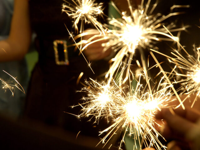 People,Holding,Beautiful,Sparklers,(fire,Crackers),In,Hands,On,A